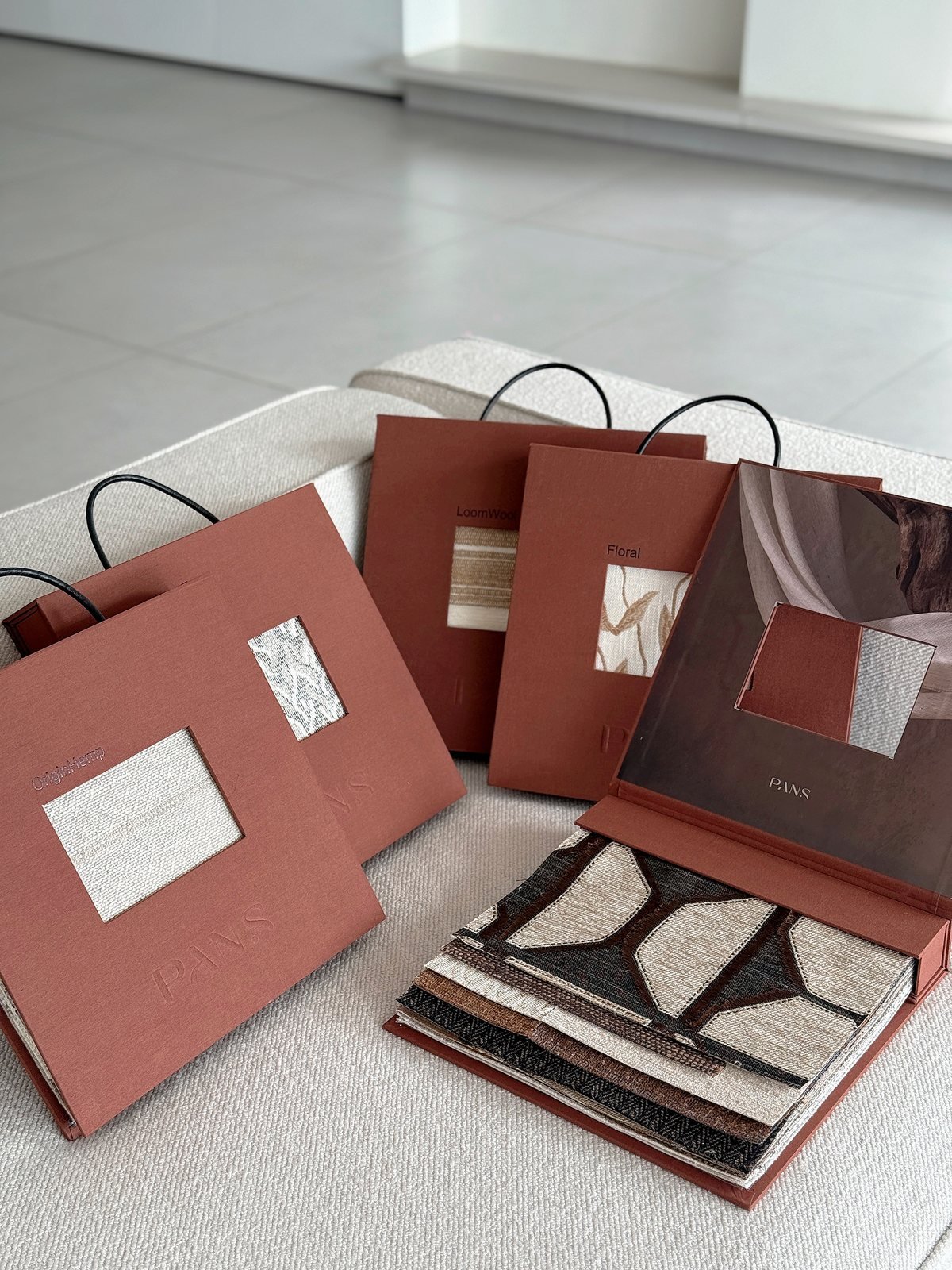 Rust coloured Ksino designer sample books with fabric windows